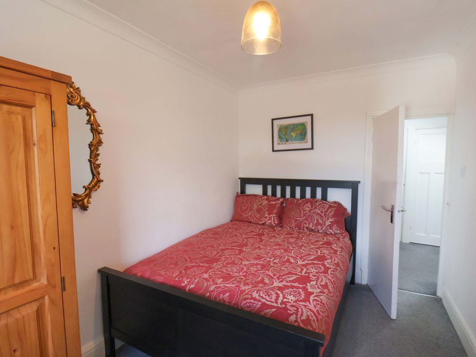 A bedroom with a bed and wardrobe at 11 Peasholm Avenue in Scarborough
