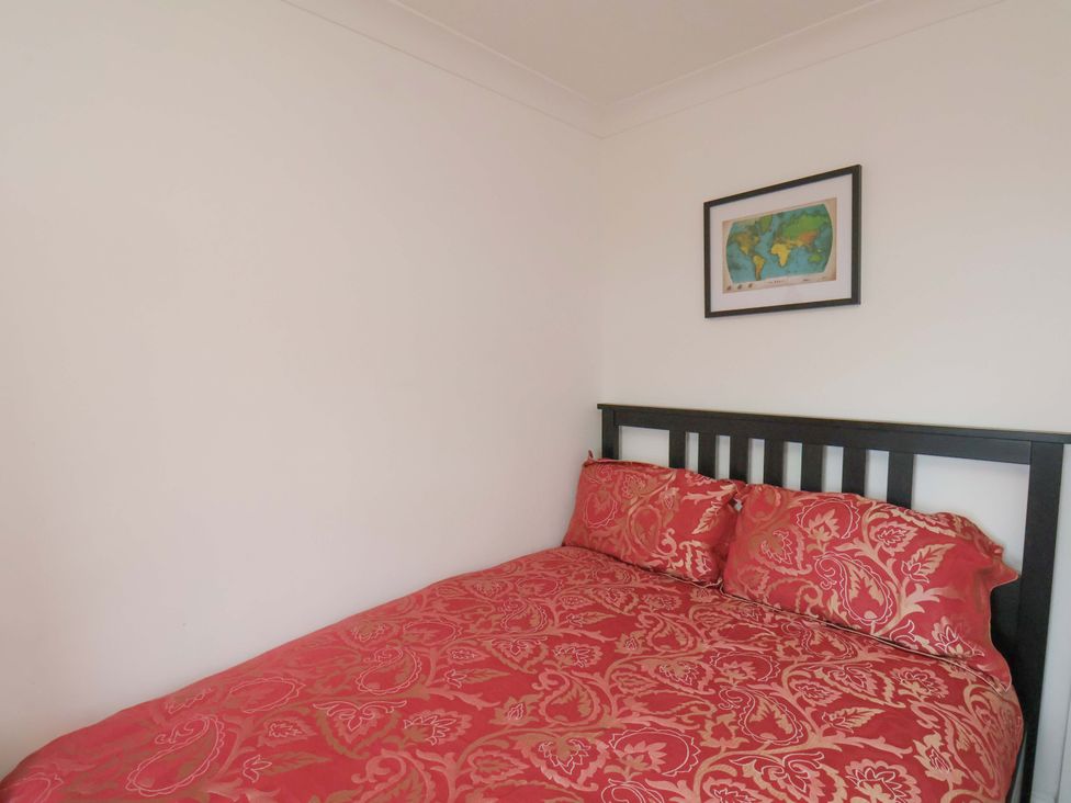 A bedroom with a bed and wall art at 11 Peasholm Avenue, Scarborough
