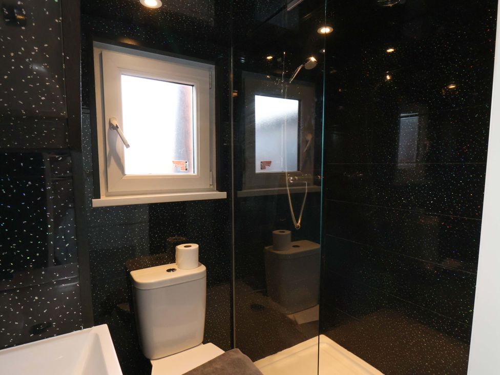 A bathroom with a shower and toilet at 11 Peasholm Avenue Scarborough