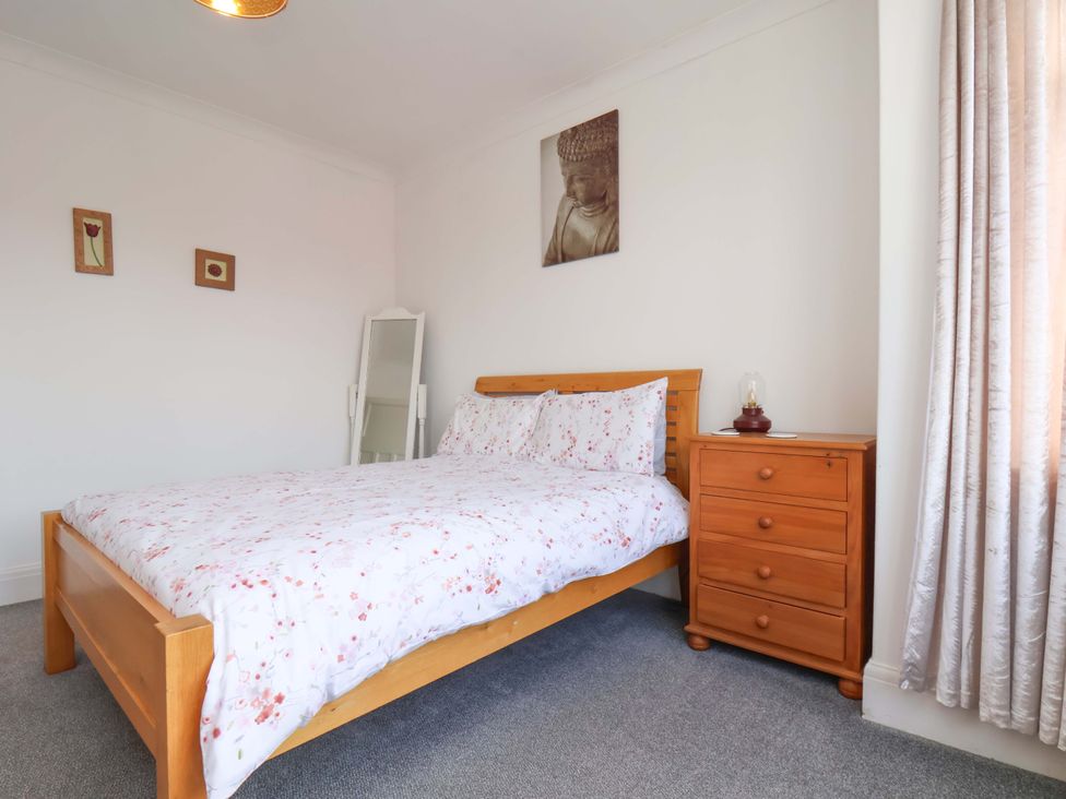 A bedroom with a bed and bedside table at 11 Peasholm Avenue, Scarborough