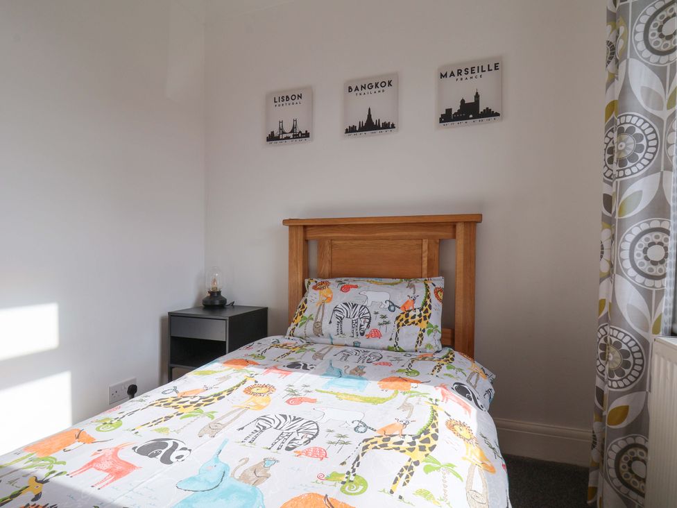 A bedroom with a bed and a bedside table at 11 Peasholm Avenue in Scarborough