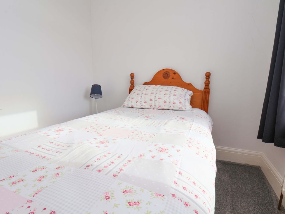 A bedroom with a bed and lamp at 11 Peasholm Avenue Scarborough