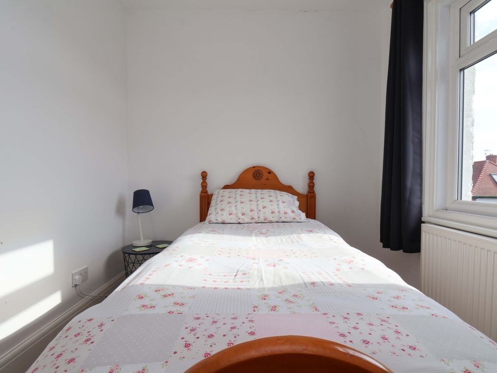 A bedroom with a bed and lamp at 11 Peasholm Avenue in Scarborough