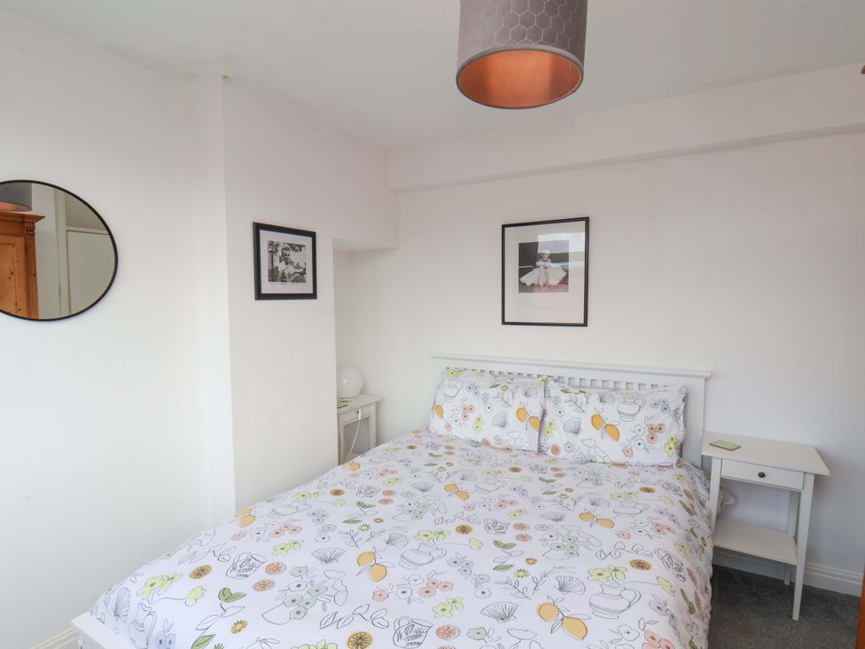 A bedroom with a bed and nightstand at 11 Peasholm Avenue, Scarborough