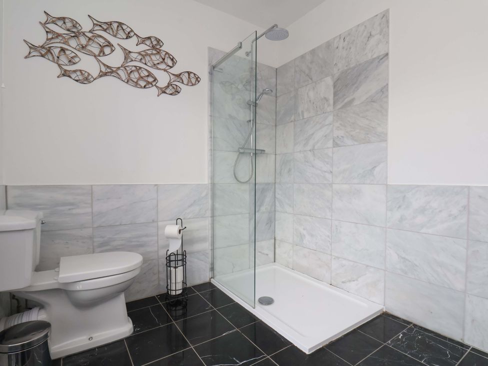 A bathroom with a shower and toilet at 11 Peasholm Avenue in Scarborough