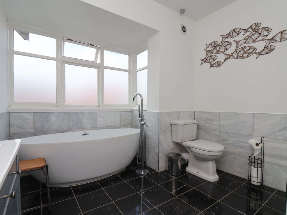 A bathroom with a bathtub and toilet at 11 Peasholm Avenue in Scarborough