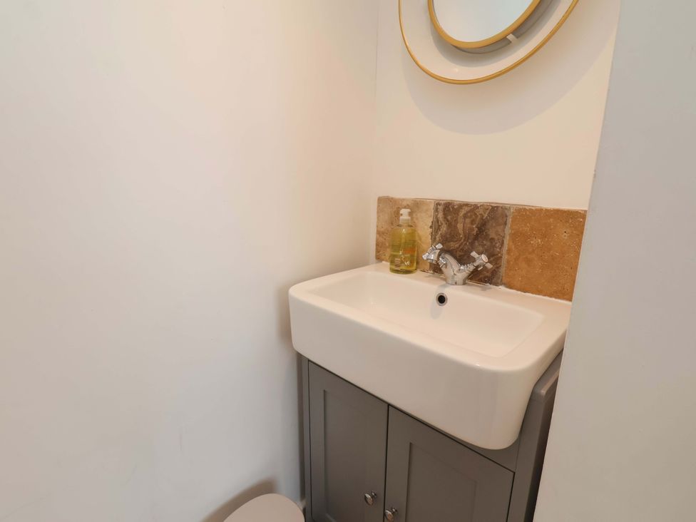 A bathroom with a sink and mirror at 11 Peasholm Avenue, Scarborough