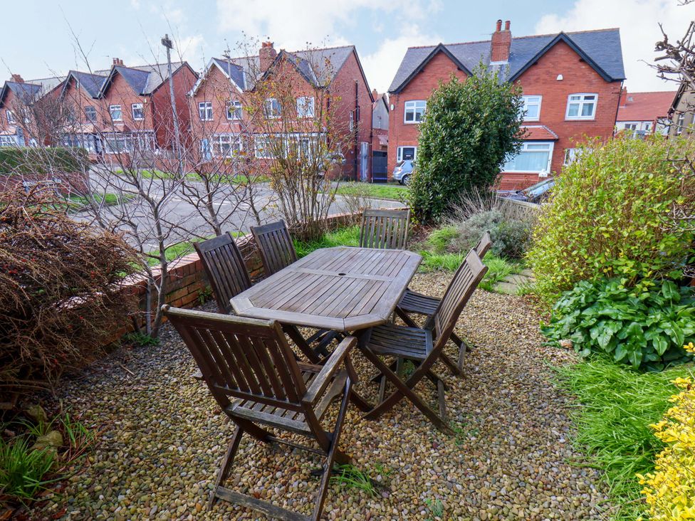 A garden with a wooden table and chairs at 11 Peasholm Avenue Scarborough