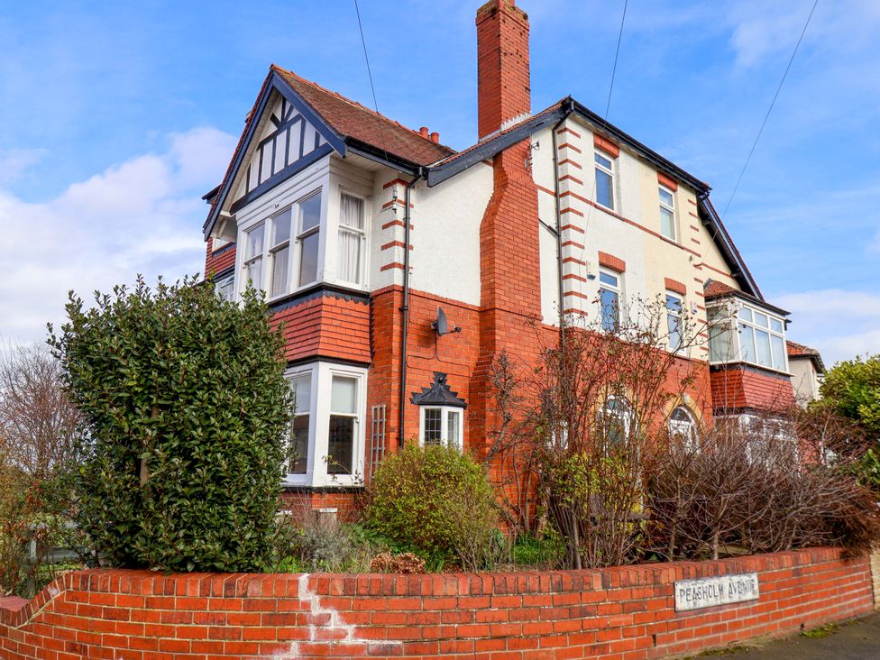 A house with brick wall and bushes at 11 Peasholm Avenue in Scarborough