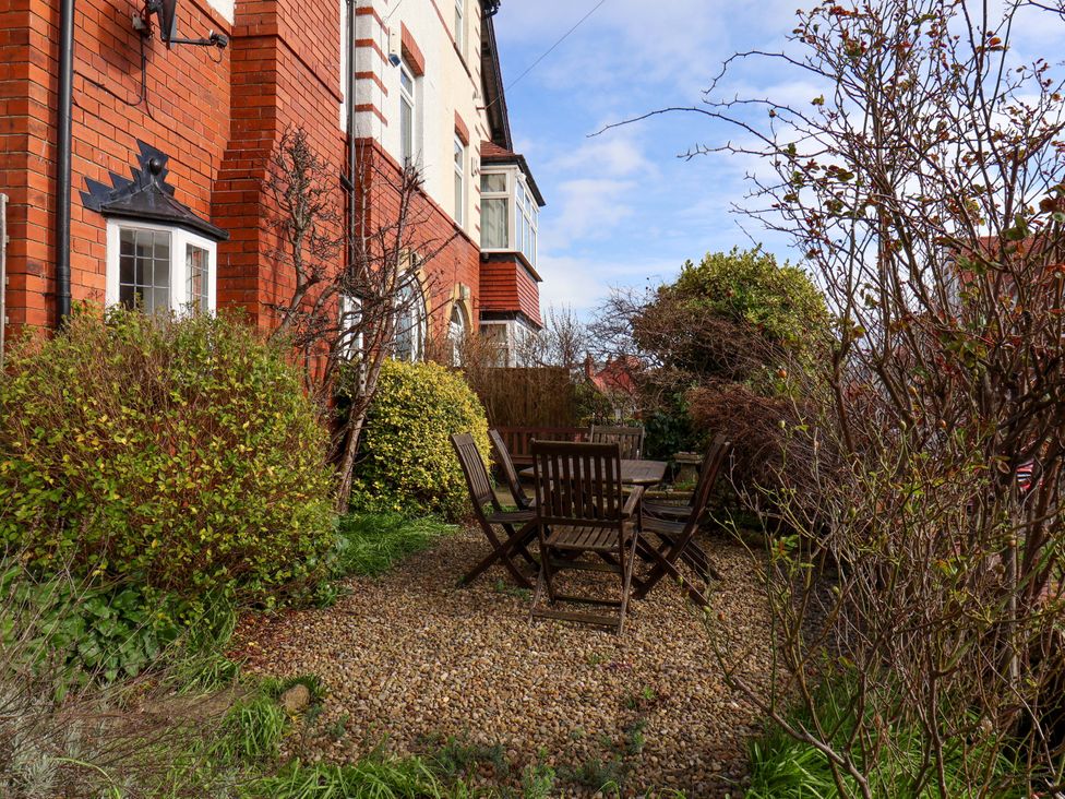 A garden with a wooden table and chairs at 11 Peasholm Avenue Scarborough