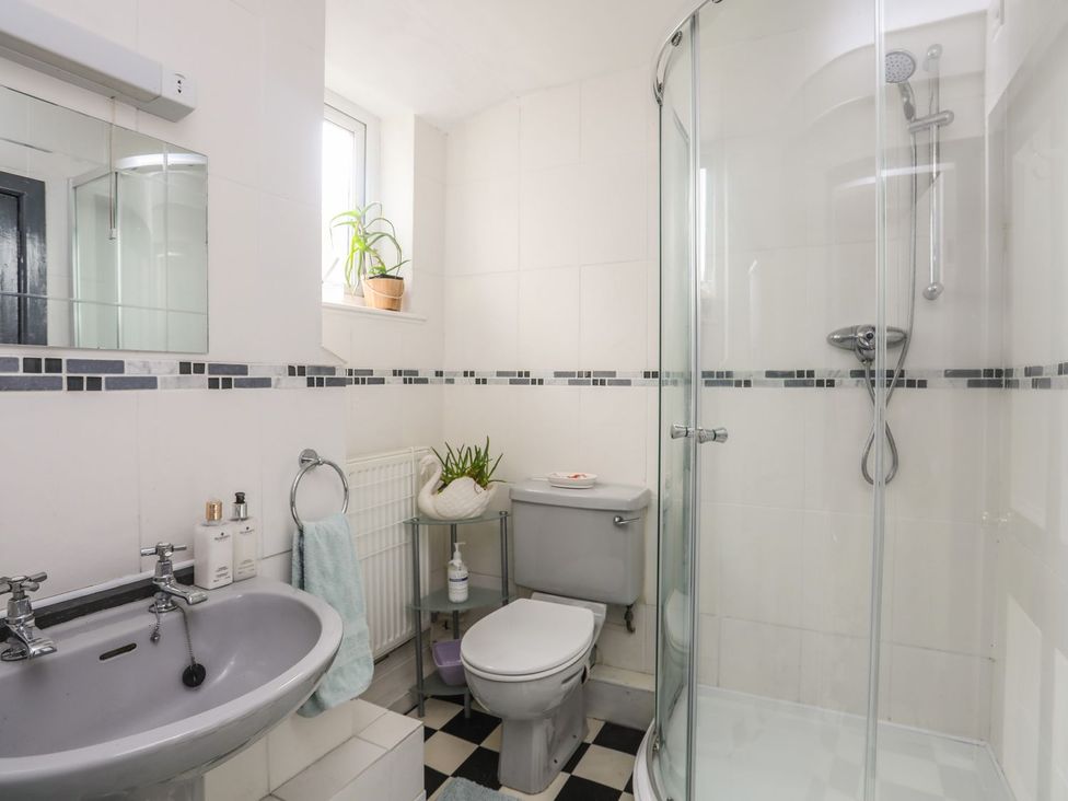 A bathroom with a shower and sink at Ty Gwenno in Criccieth