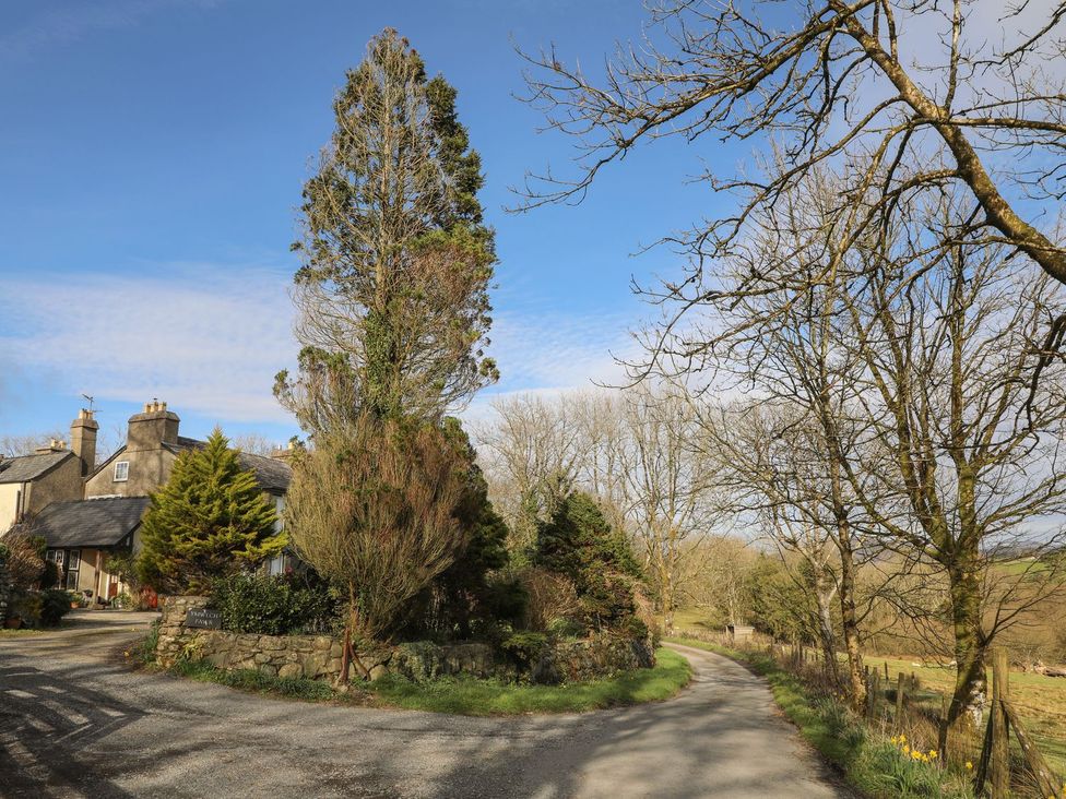 A house with a driveway and trees at Ty Gwenno in Criccieth