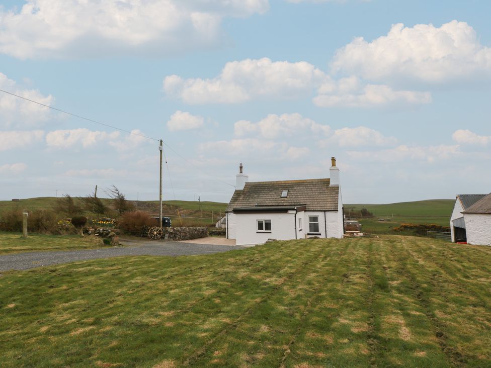 An outdoor view of a house with grass at South Kirklauchline Farm Stoneykirk near Sandhead