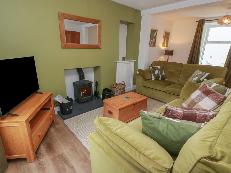 A living room with a sofa and television at South Kirklauchline Farm in Stoneykirk near Sandhead