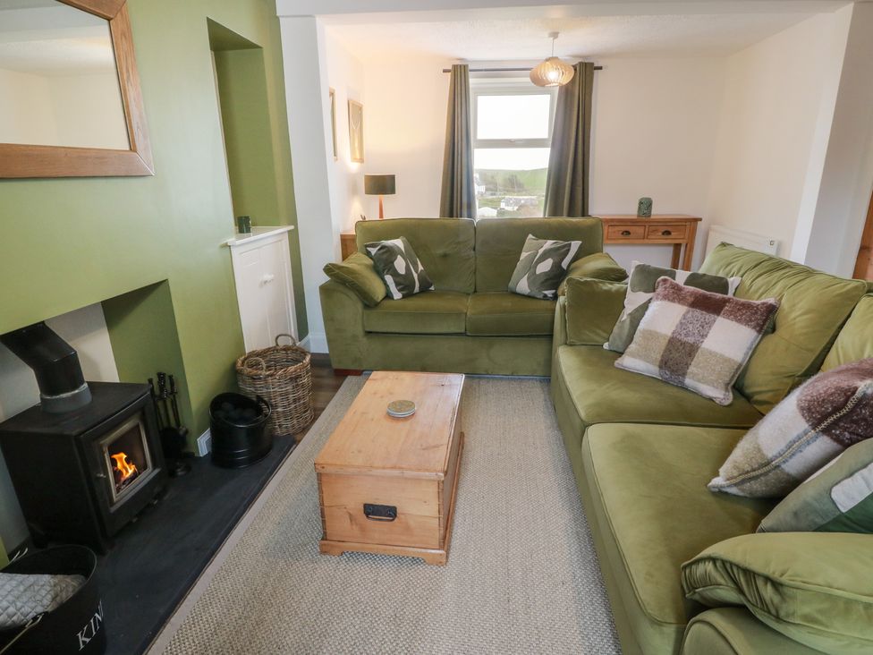 A living room with a sofa and coffee table at South Kirklauchline Farm Stoneykirk near Sandhead