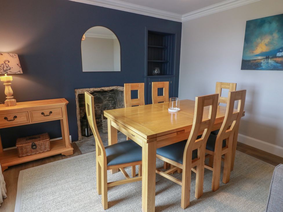 A dining room with a wooden table and chairs at South Kirklauchline Farm Stoneykirk near Sandhead