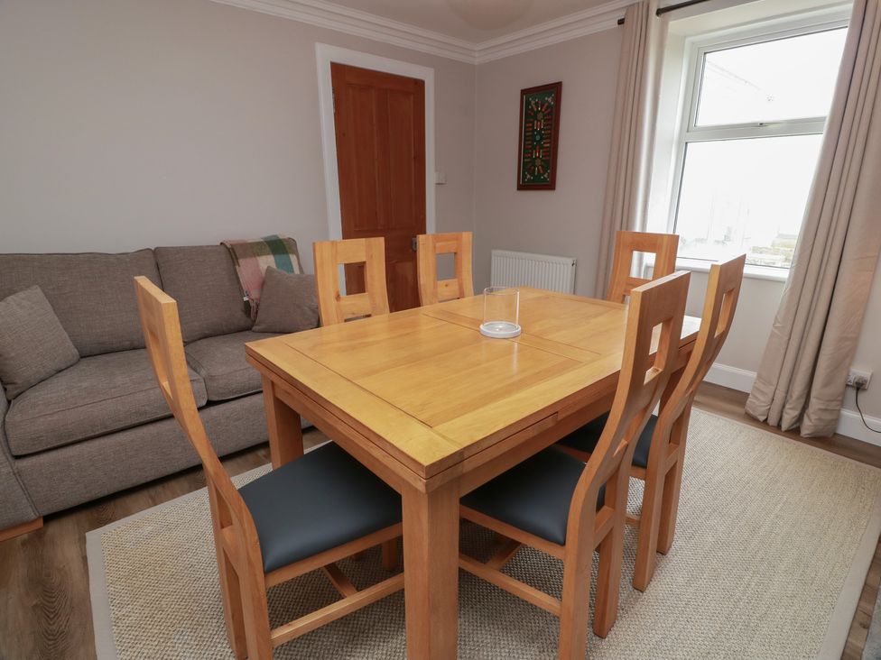 A dining room with a table and chairs at South Kirklauchline Farm Stoneykirk near Sandhead