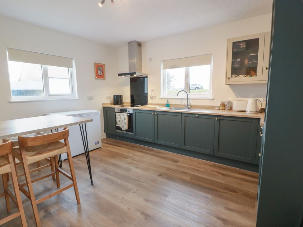 A kitchen with a cooking range and refrigerator at South Kirklauchline Farm Stoneykirk near Sandhead