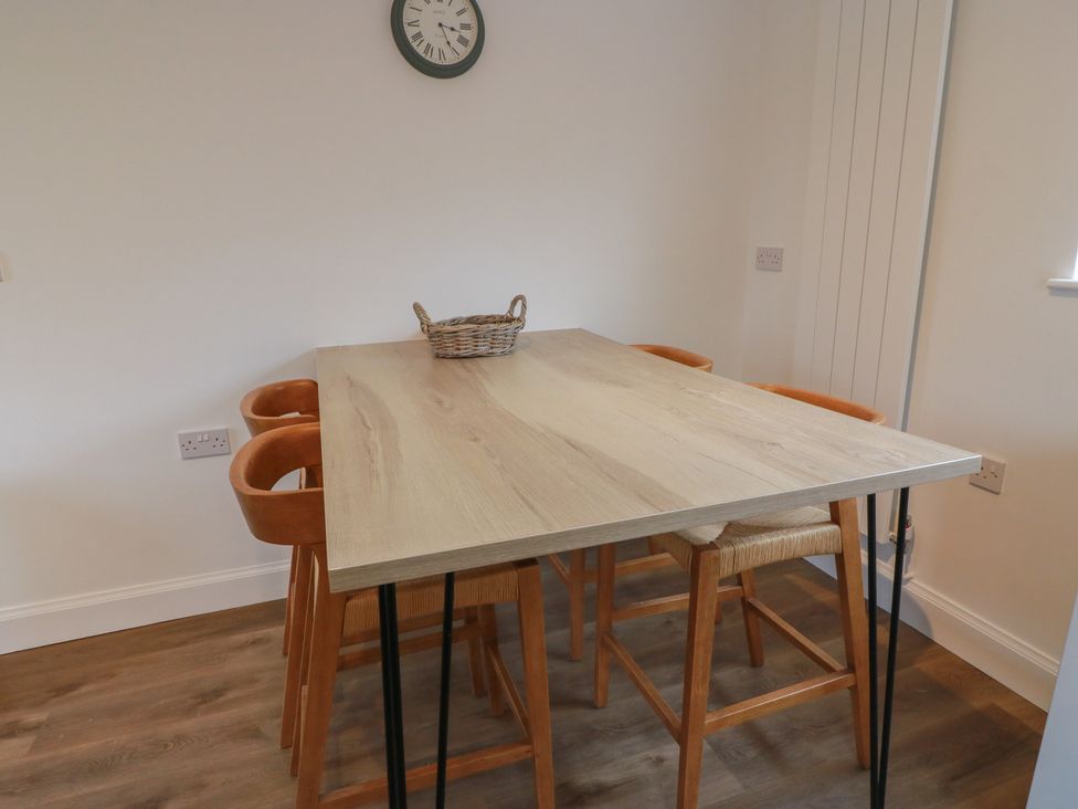 A dining room with a table and chairs at South Kirklauchline Farm in Stoneykirk near Sandhead