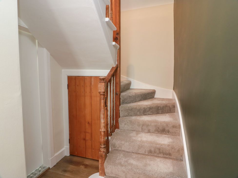 A staircase with a handrail and door at South Kirklauchline Farm in Stoneykirk near Sandhead