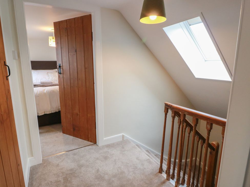 A hallway with stairs and doors leading to a bedroom at South Kirklauchline Farm Stoneykirk near Sandhead