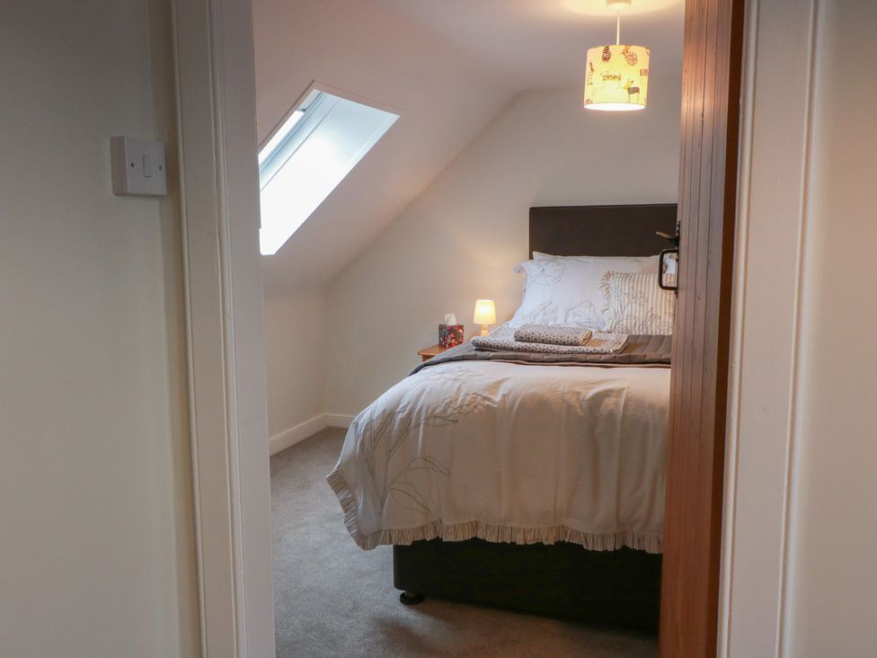 A bedroom with a bed and bedside table at South Kirklauchline Farm in Stoneykirk near Sandhead