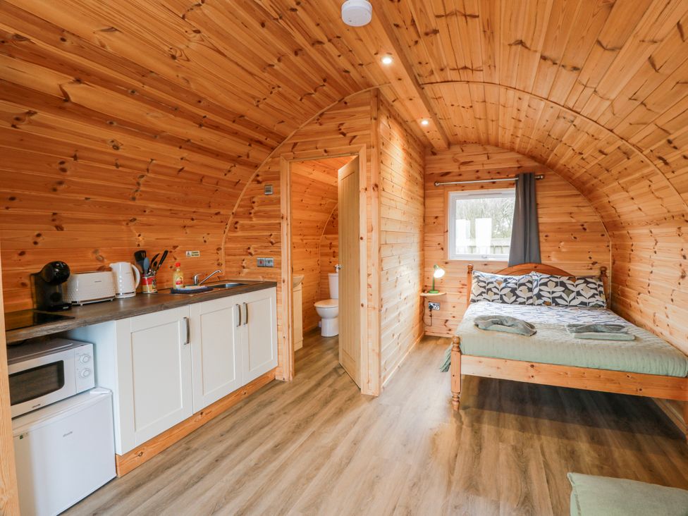 A studio with a bed and kitchen area at Keith in Stoneykirk near Sandhead