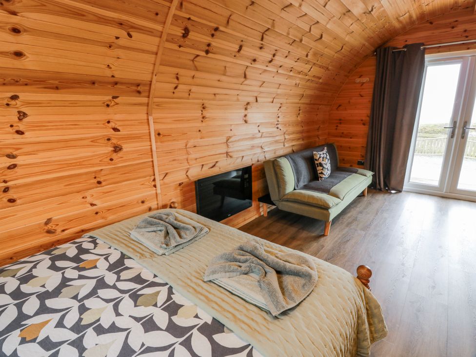 A bedroom with a bed and a couch at Keith in Stoneykirk near Sandhead