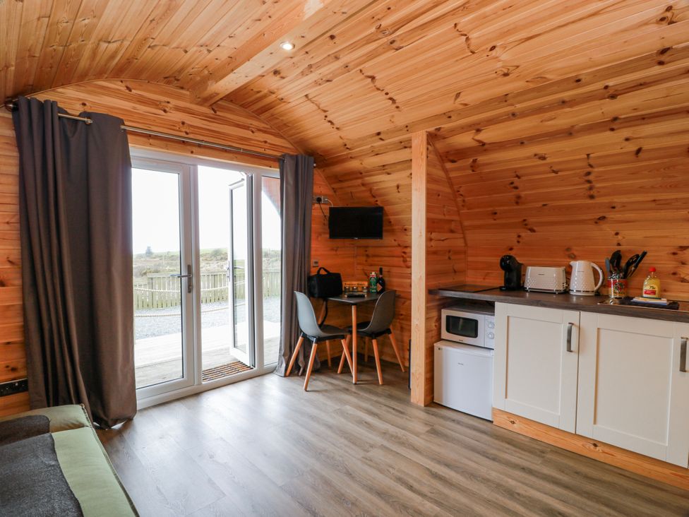 An interior view of a cabin with a kitchen and seating area at Keith in Stoneykirk near Sandhead