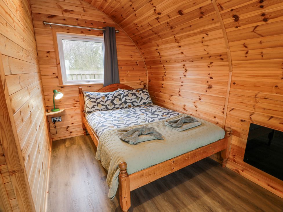 A bedroom with a bed and bedside lamp at Keith in Stoneykirk near Sandhead