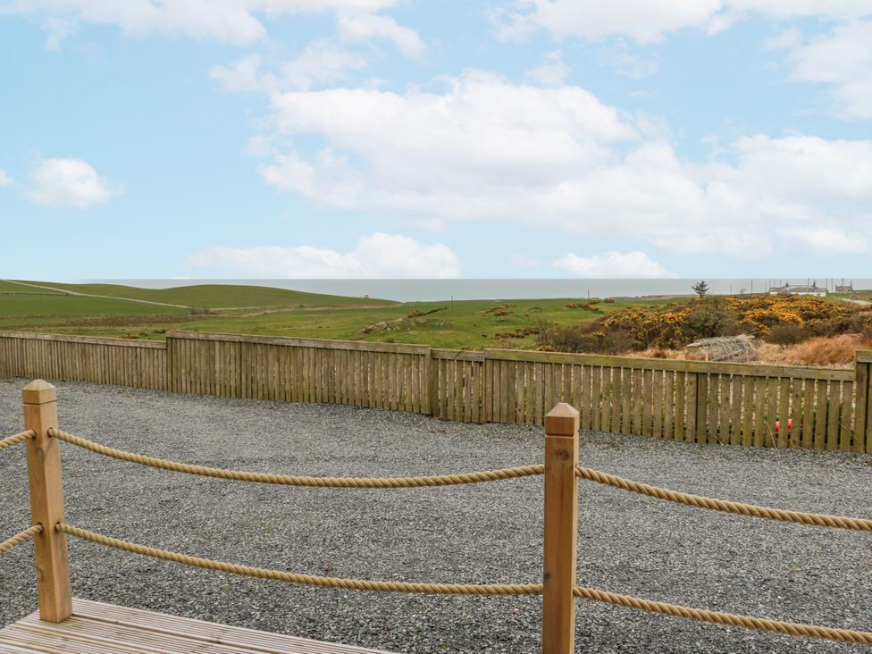 An outdoor area with a gravel surface and a fence at Keith in Stoneykirk near Sandhead