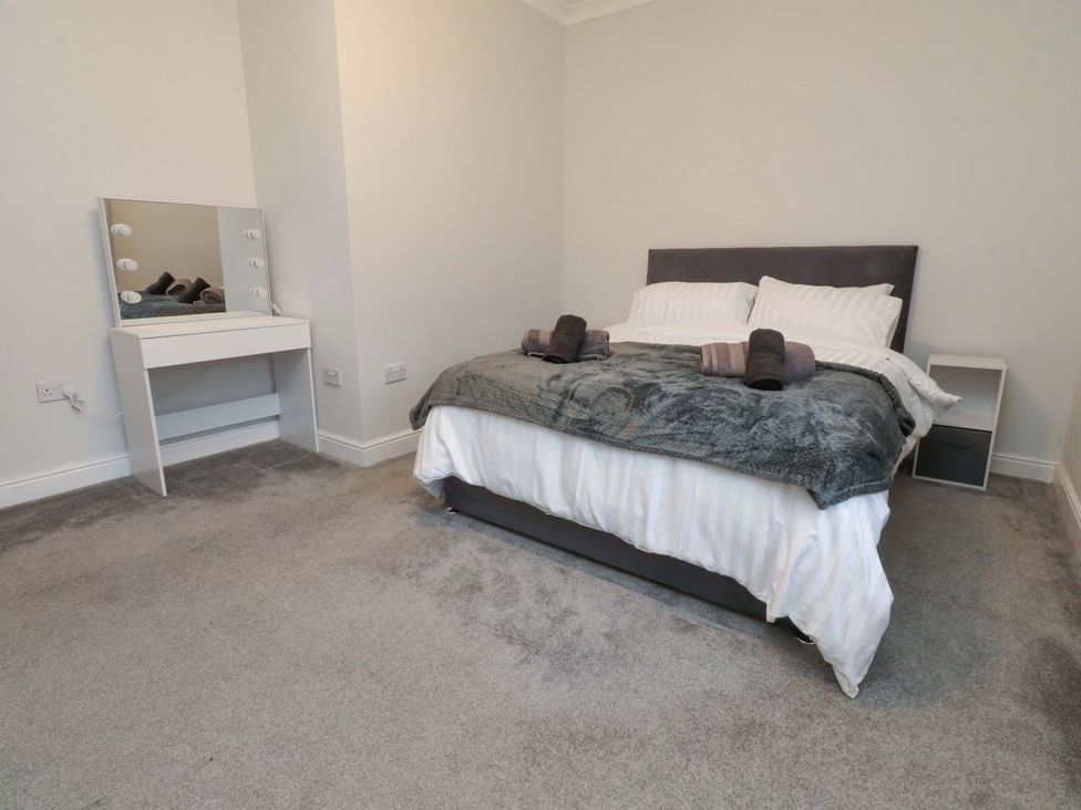 A bedroom with a bed and mirror at 46 Marlborough Road Accrington