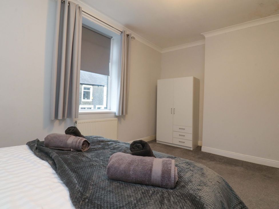 A bedroom with towels on the bed at 46 Marlborough Road, Accrington