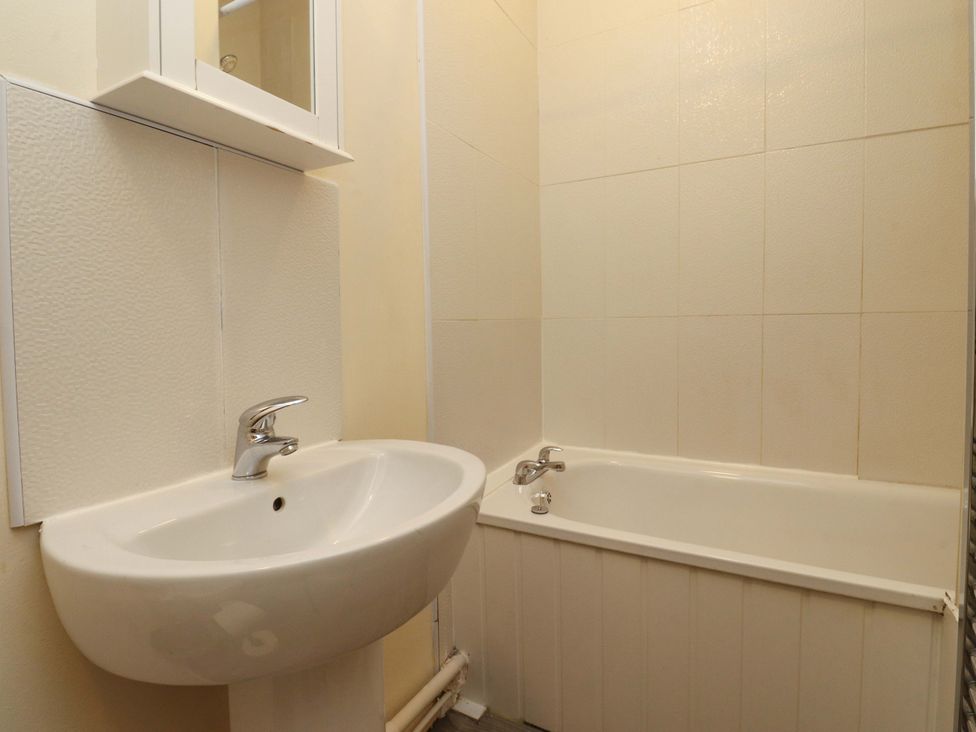 A bathroom with a sink and bathtub at 46 Marlborough Road in Accrington