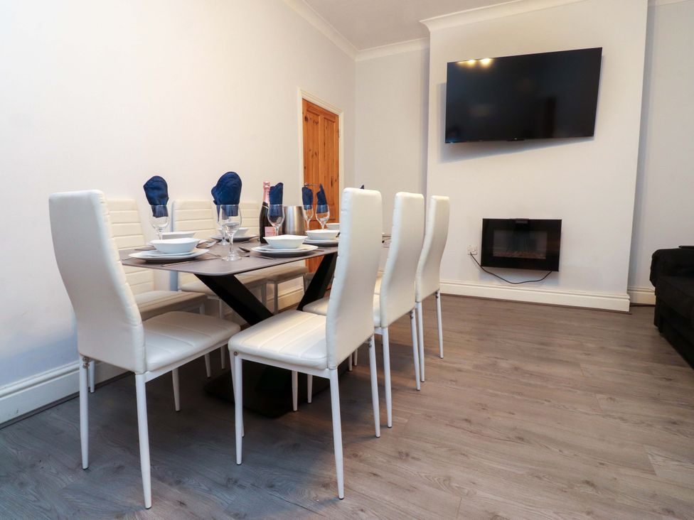 A dining area with a table and chairs at Victoria Place in Accrington