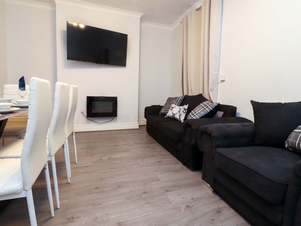 A living room with a sofa and television at Victoria Place in Accrington
