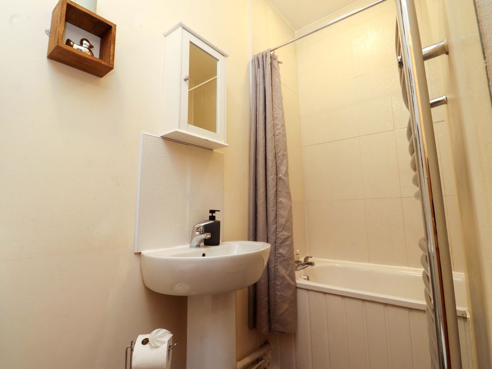 A bathroom with a wash basin and bathtub at Victoria Place in Accrington