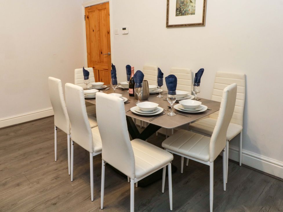 A dining room with a table set for dinner at Victoria Place in Accrington