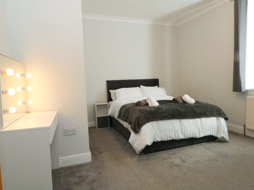A bedroom with a bed and a vanity unit at Victoria Place in Accrington