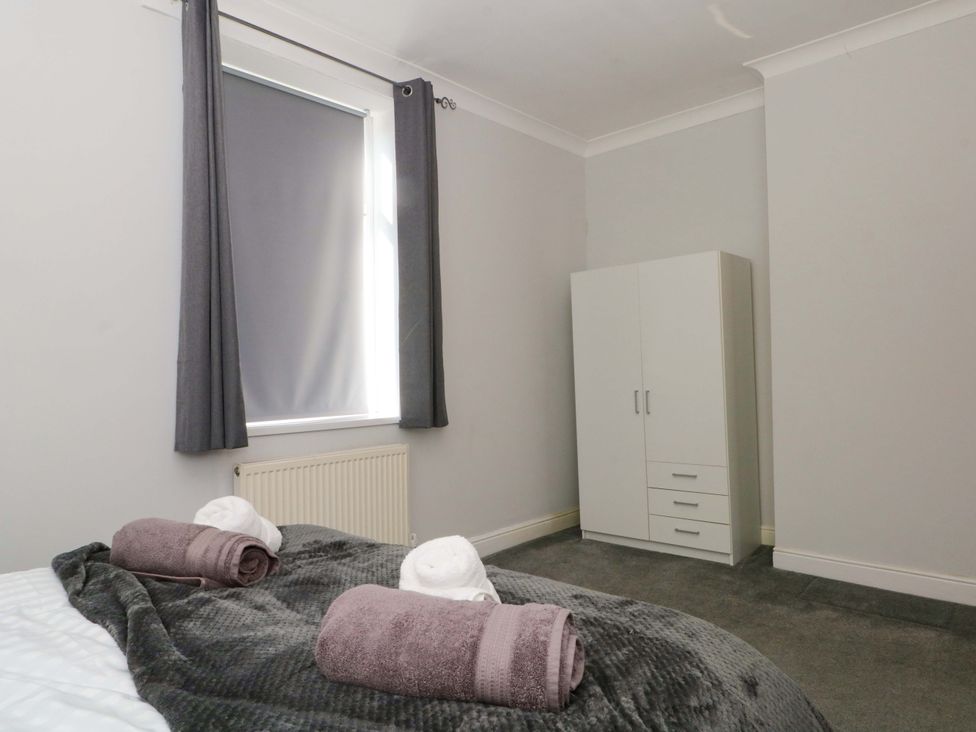 A bedroom with a bed and a wardrobe at Victoria Place Accrington