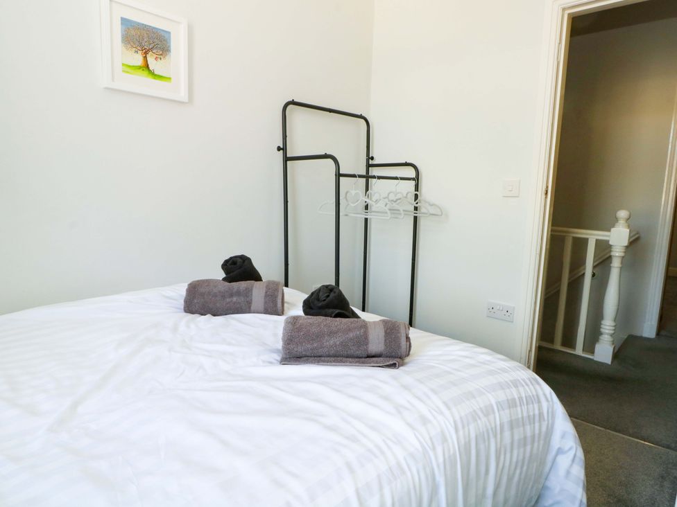 A bedroom with a bed and towels on it at Victoria Place in Accrington