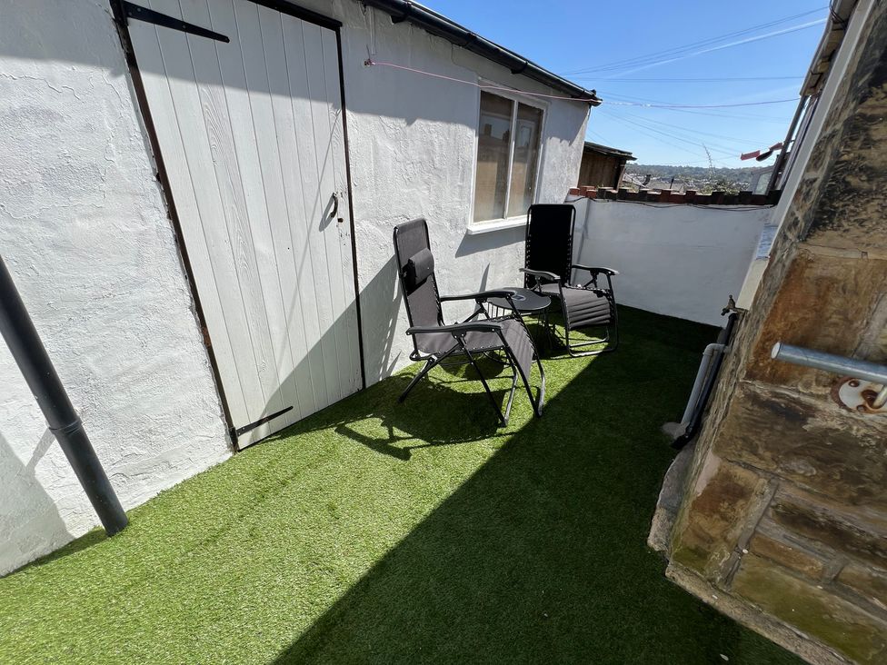 An outdoor area with chairs and a table at Victoria Place in Accrington