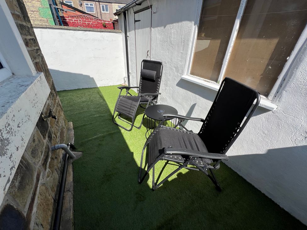 An outdoor area with two chairs and a table at Victoria Place in Accrington