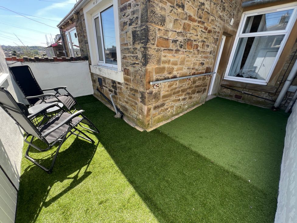 An outdoor area with chairs and artificial grass at Victoria Place Accrington