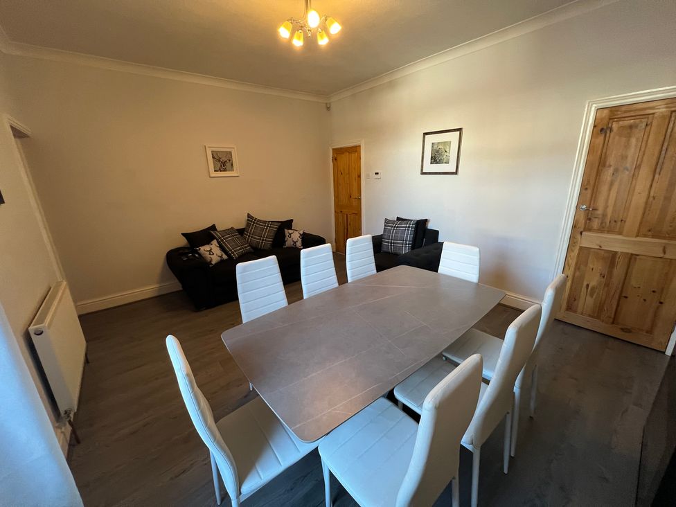 A dining room with a table and chairs at Victoria Place in Accrington
