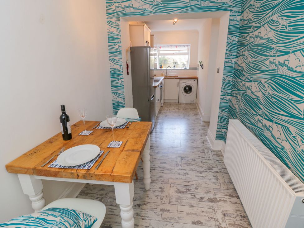 A dining room with a table and chairs at The Hideaway in Whitby