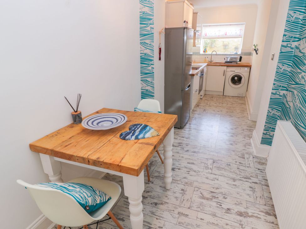 A kitchen with a table and chairs at The Hideaway in Whitby