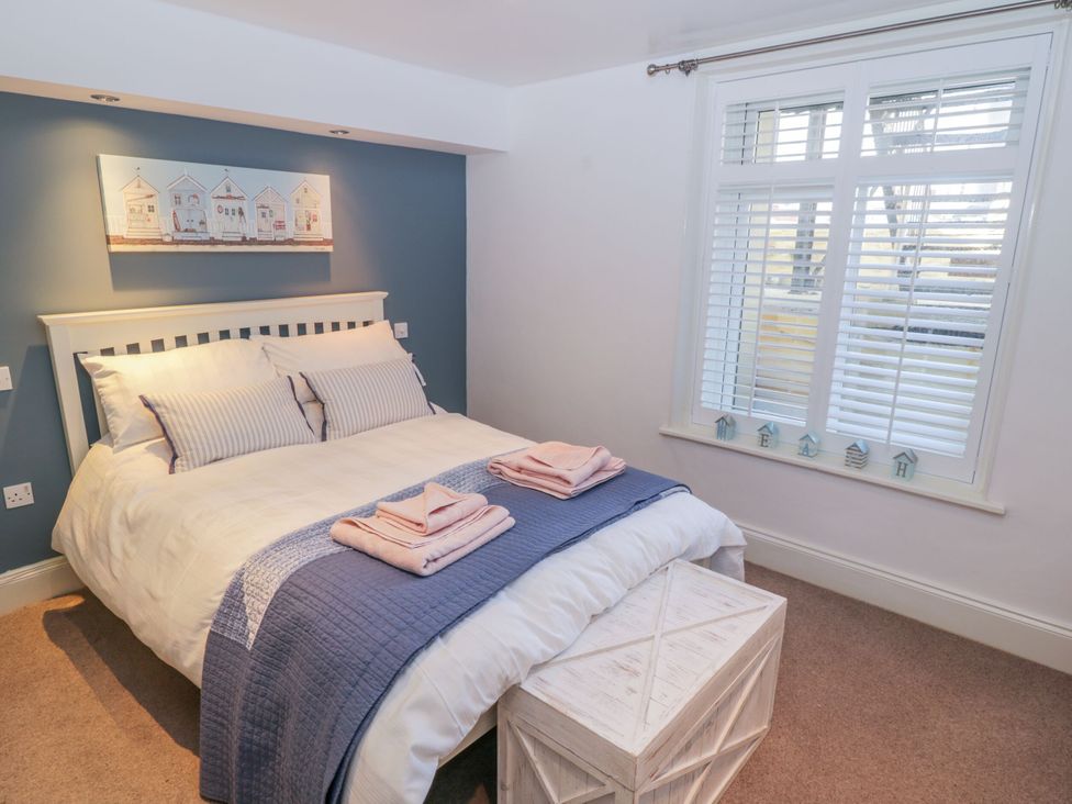 A bedroom with a bed and window at The Hideaway in Whitby