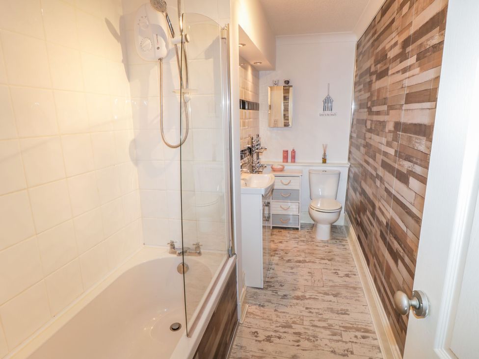 A bathroom with a bathtub and shower at The Hideaway in Whitby