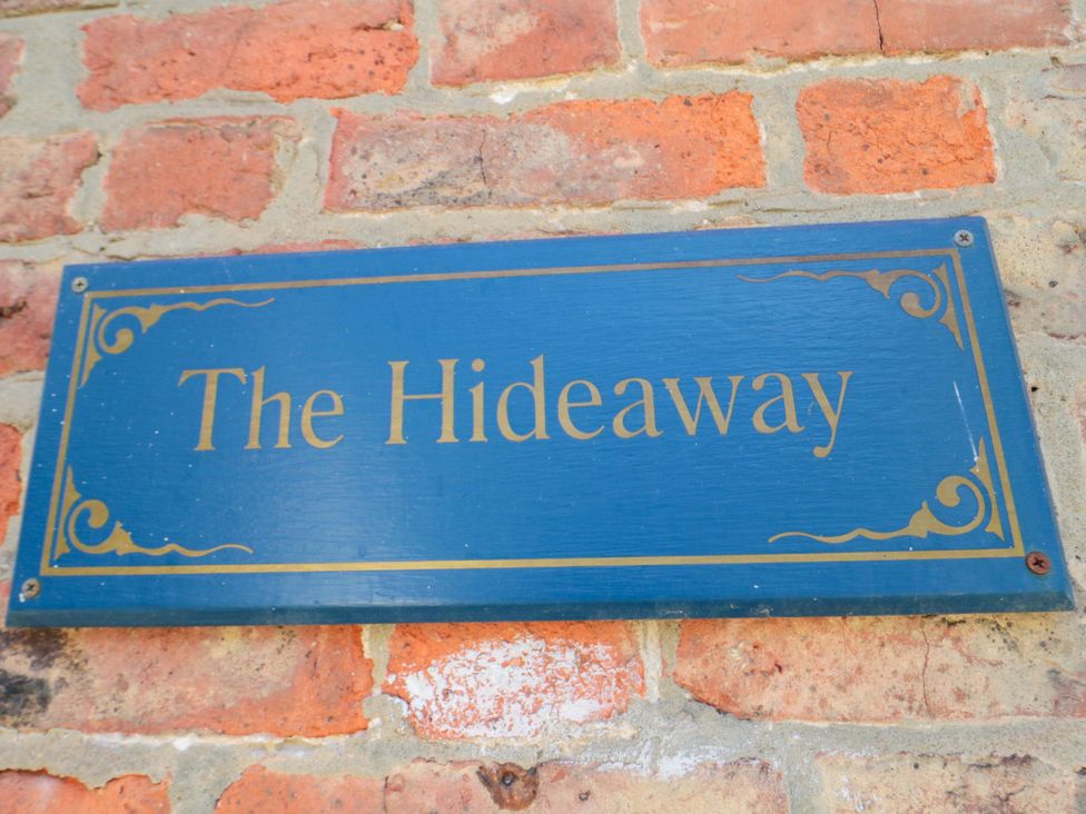 A sign that says The Hideaway on a brick wall at The Hideaway in Whitby